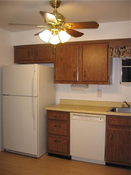 The kitchen is fully equipped with a fridge, dishw