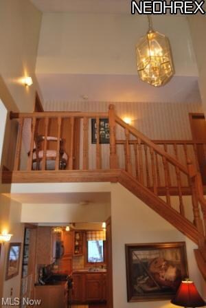 Two story foyer with hardwood flooring and chandel