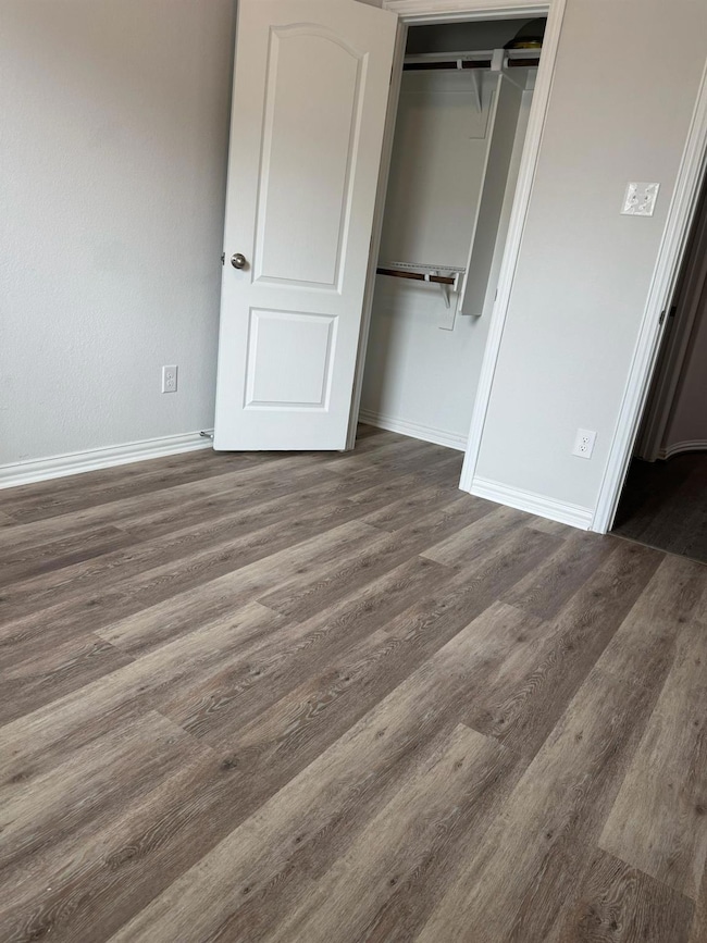 Unfurnished bedroom featuring wood finished floor