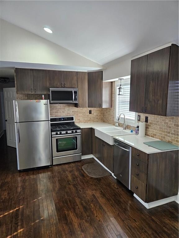 Kitchen with light countertops, lofted ceiling, da