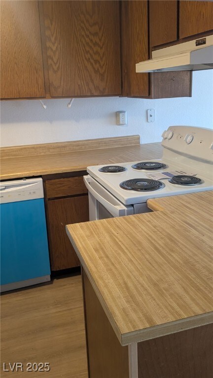 Kitchen featuring electric stove, light countertop