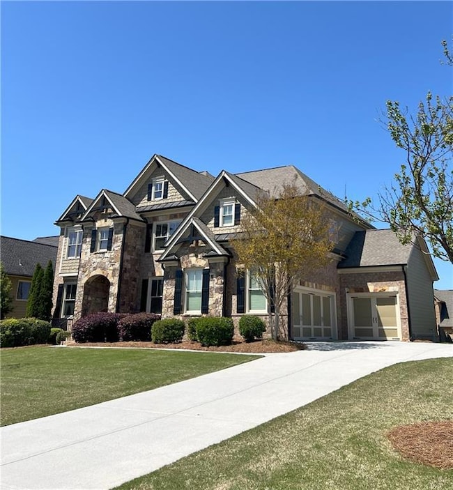 Craftsman-style home featuring a front lawn, stone
