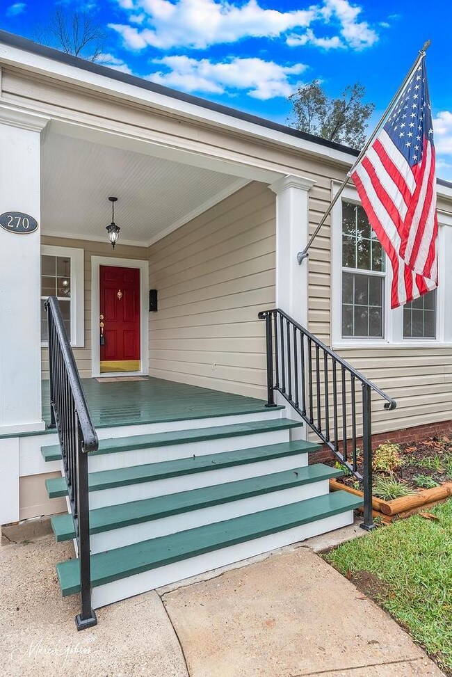 Doorway to property featuring a porch