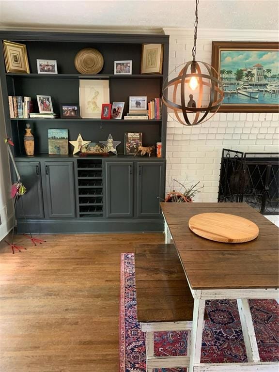 Dining room featuring wood finished floors and a fireplace