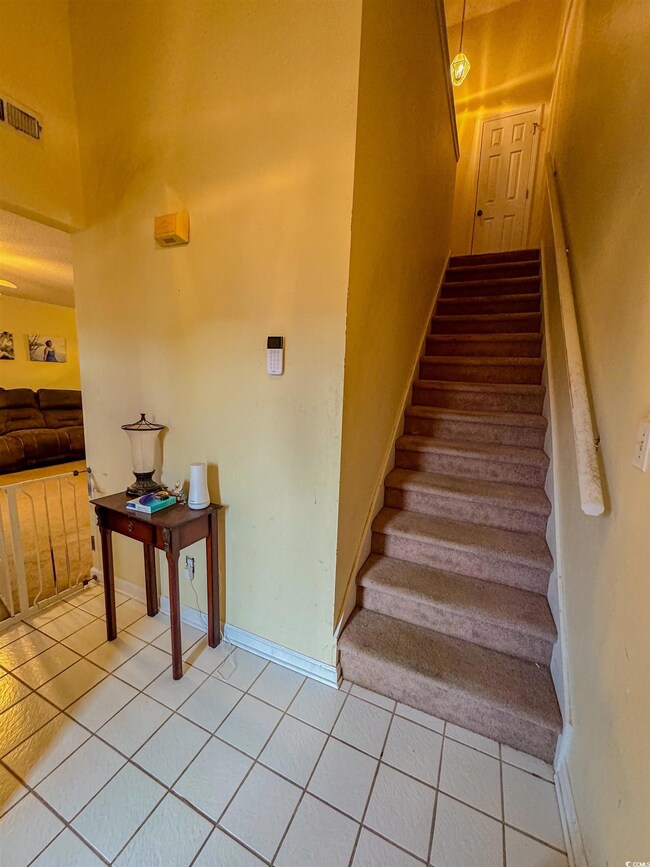 Staircase with tile patterned floors