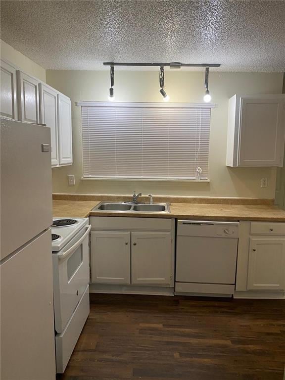 Kitchen with white appliances, dark hardwood / woo