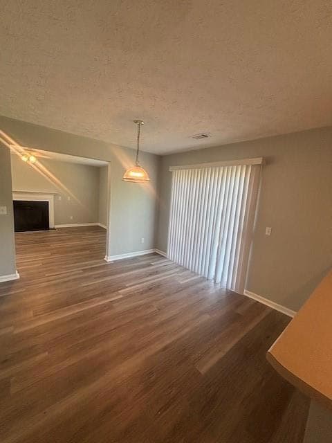 Unfurnished dining area with visible vents, basebo