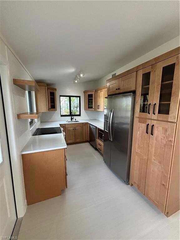 Kitchen featuring dishwashing machine, fridge, and