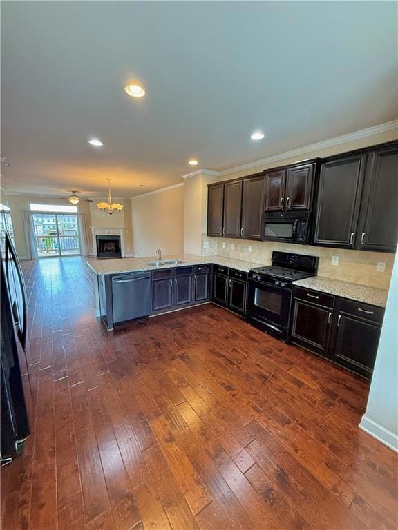 Kitchen featuring black appliances, open floor pla