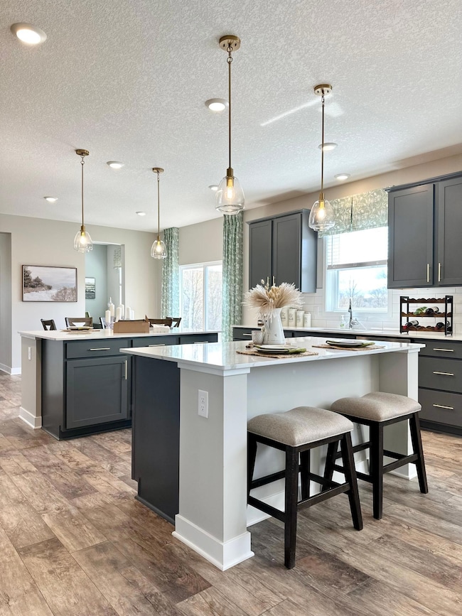 A must see kitchen with 2 center islands. Perfect for the chef in your home, entertaining and everyday living. Photo of model home, colors and finishes will vary.