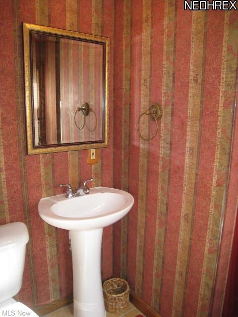 Full bath on main floor with pedestal sink.