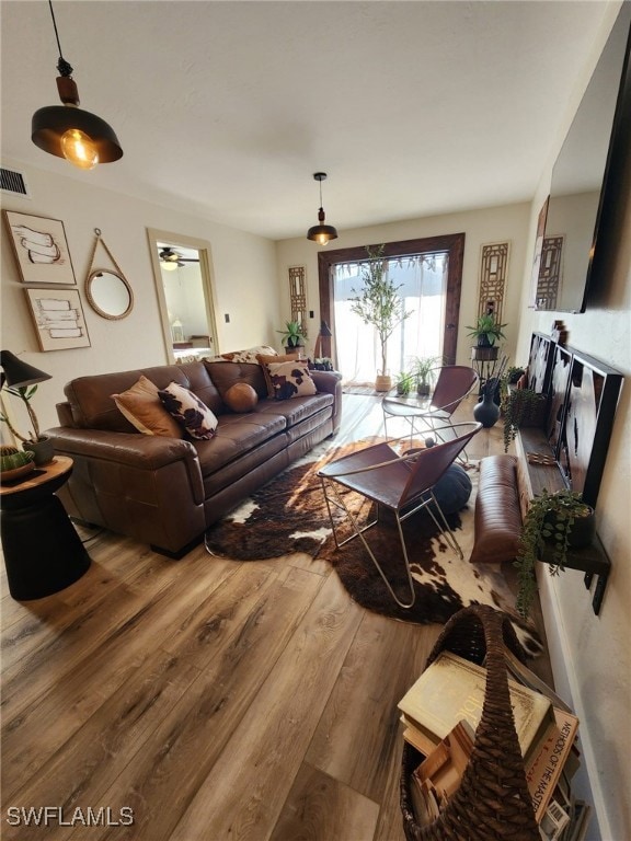 Living area featuring wood finished floors and vis