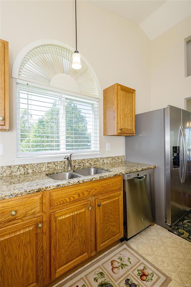 The kitchen has vaulted ceilings and a double sink