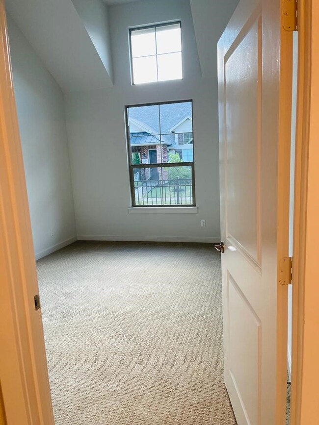 Carpeted spare room with baseboards