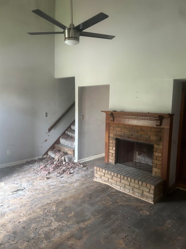 Unfurnished living room with a brick fireplace and