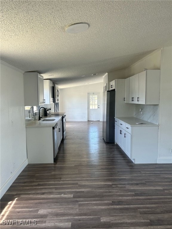 Kitchen with dark wood-type flooring, light counte