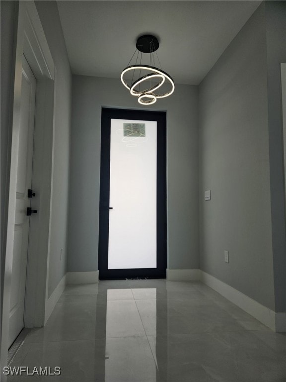 Unfurnished room with an inviting chandelier and b