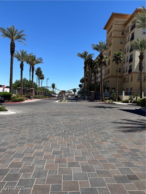 View of road featuring street lights, a gated entr