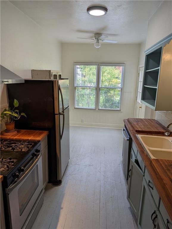 Kitchen with wood counters, stainless steel appli