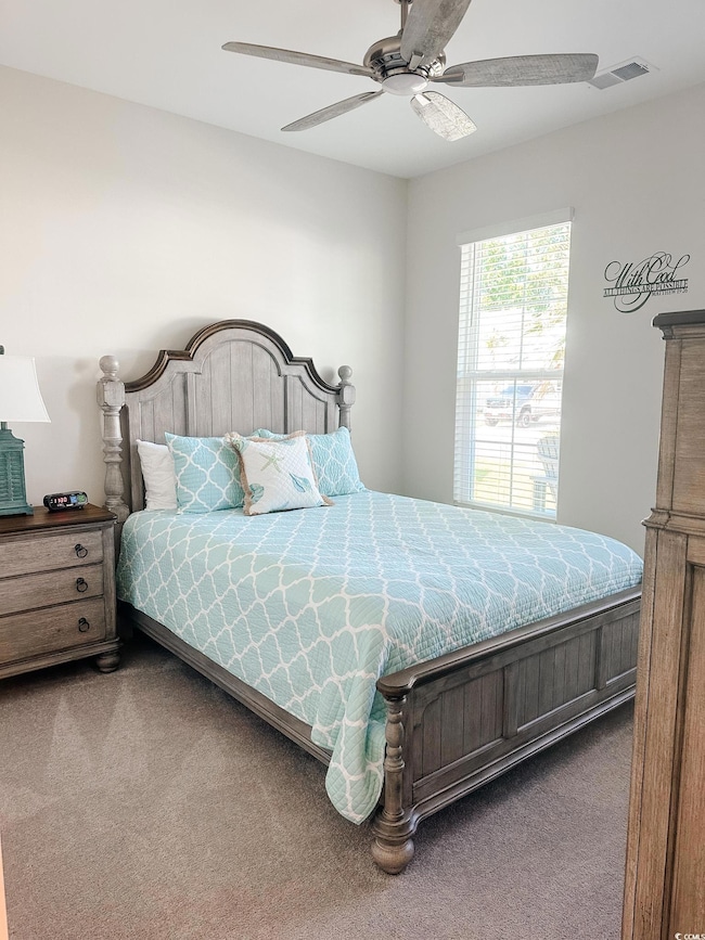 Bedroom featuring carpet and ceiling fan