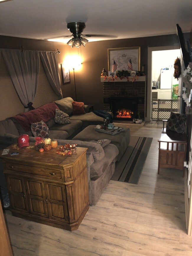 Living room with a fireplace and ceiling fan! 941 Oak St, Lewisburg, TN 37091