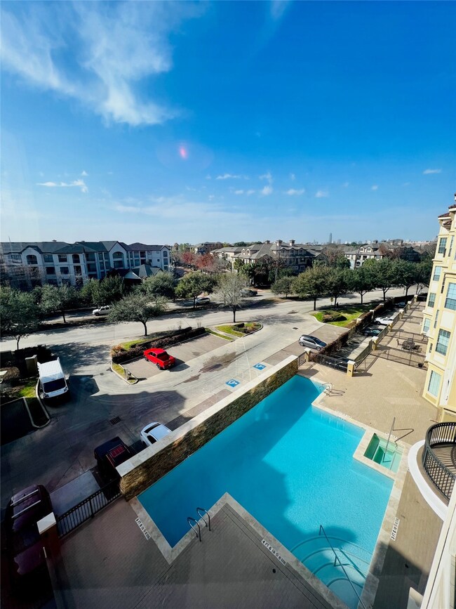 View from your living room of the beautiful pool and hot tub.  Condo faces Kirby Dr.