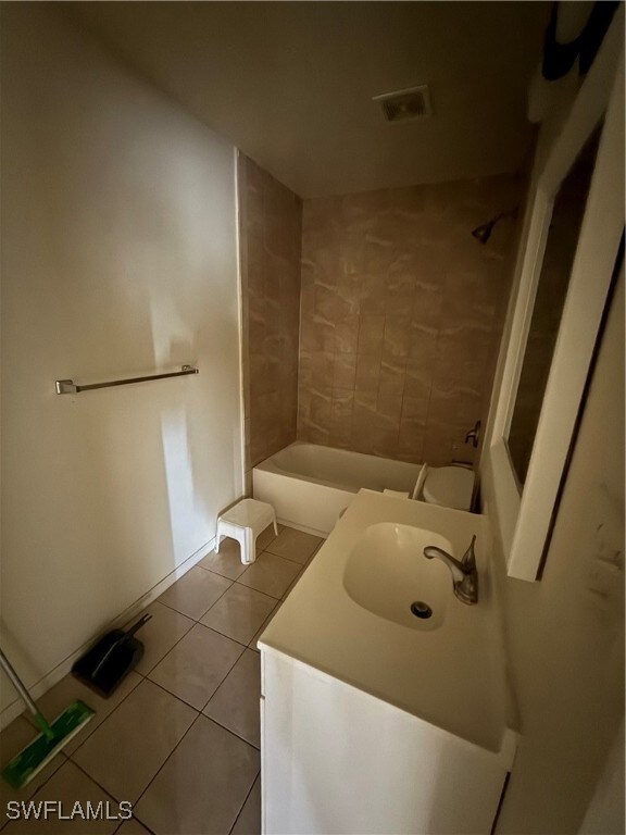 Bathroom with tile patterned floors, vanity, and bathing tub / shower combination