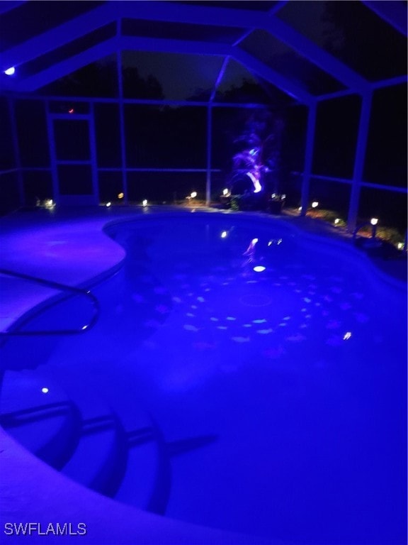 Pool at twilight featuring an outdoor pool and a l