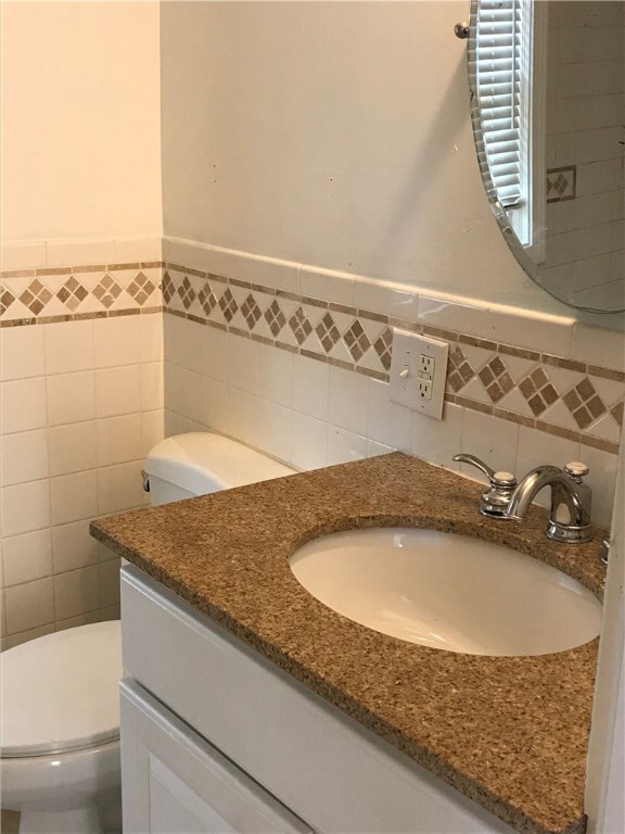 First floor full bath is updated with granite coun