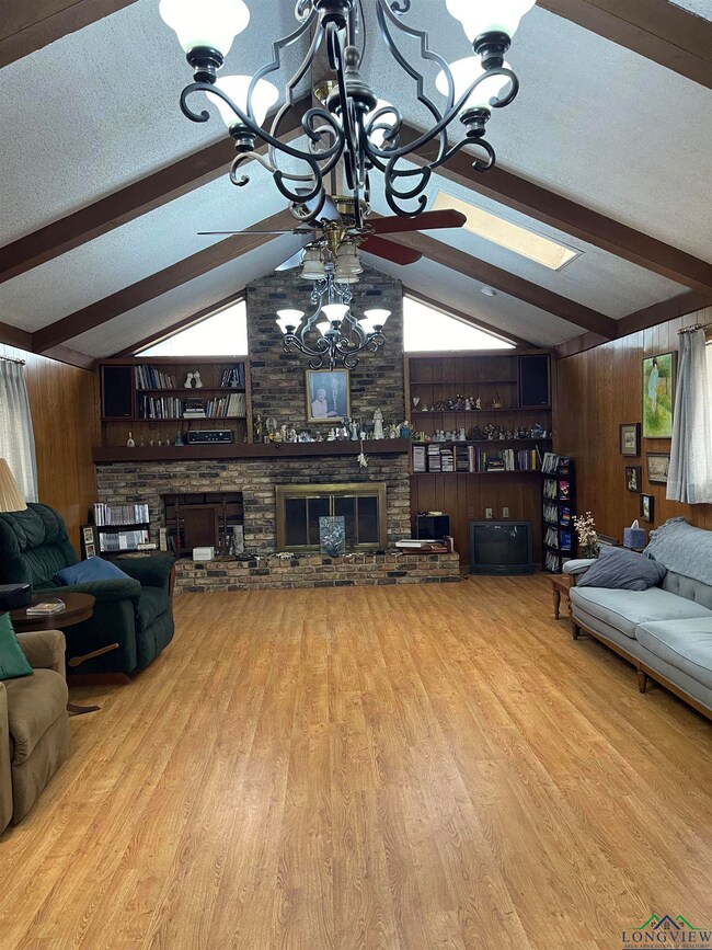 Living room featuring vaulted ceiling with beams, 