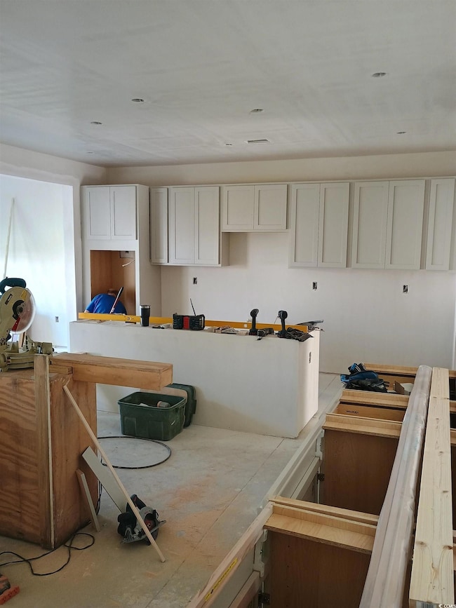 Kitchen featuring white cabinets