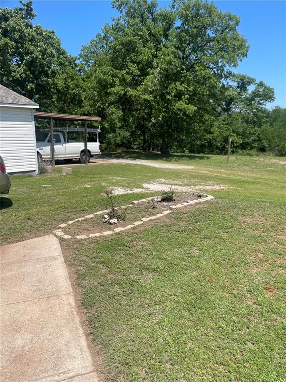 Front yard looking at side of 2 car garage and car