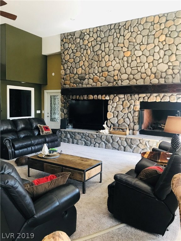 Main house Great room with full wall river rock fi