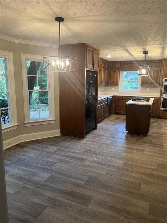 Kitchen with pendant lighting, light countertops, a chandelier, and vinyl flooring (all new)