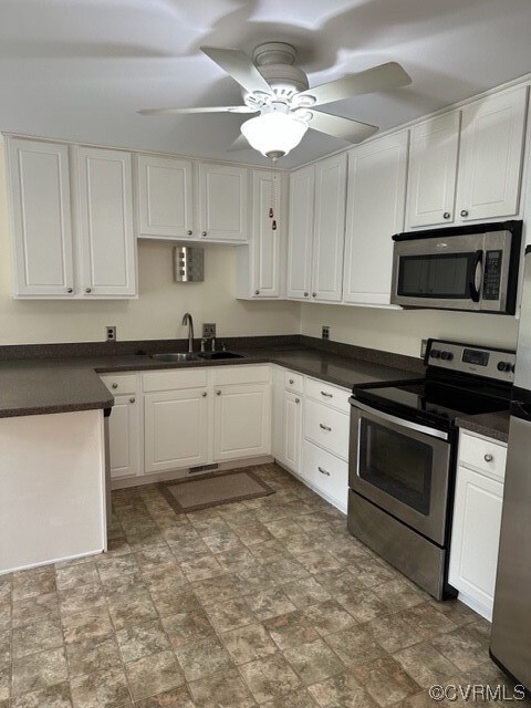 Kitchen with white cabinetry, ceiling fan