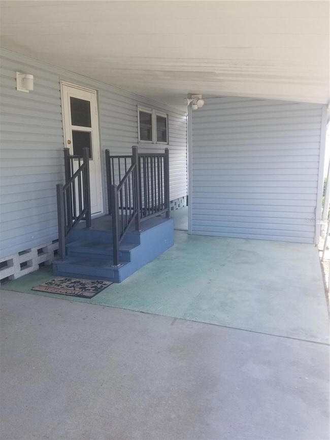 Stairs to side door. Storage shed behind wall.