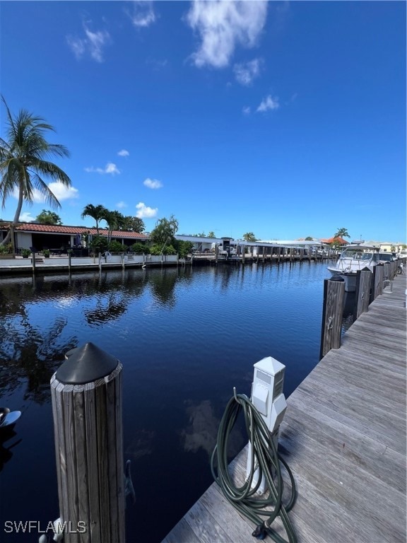 Dock area featuring a water view