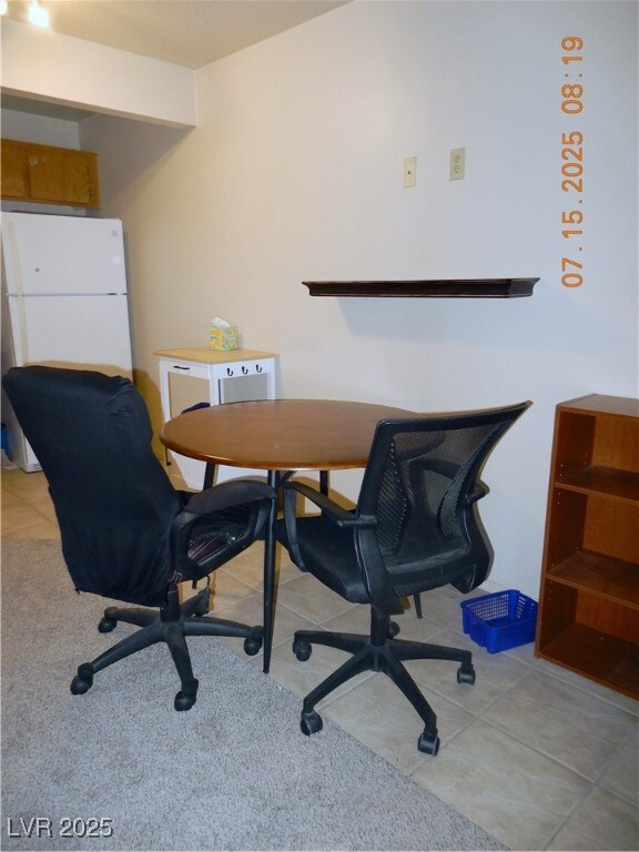 Dining area with light tile patterned flooring