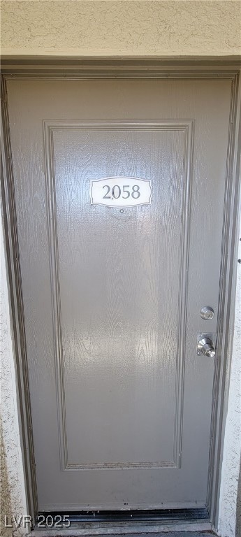 Entrance to property featuring stucco siding