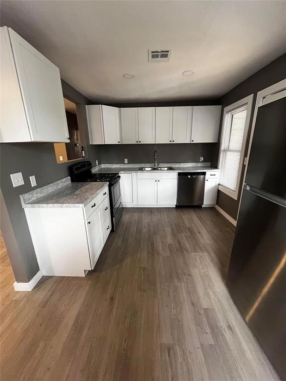 Kitchen featuring stainless steel dishwasher, whit