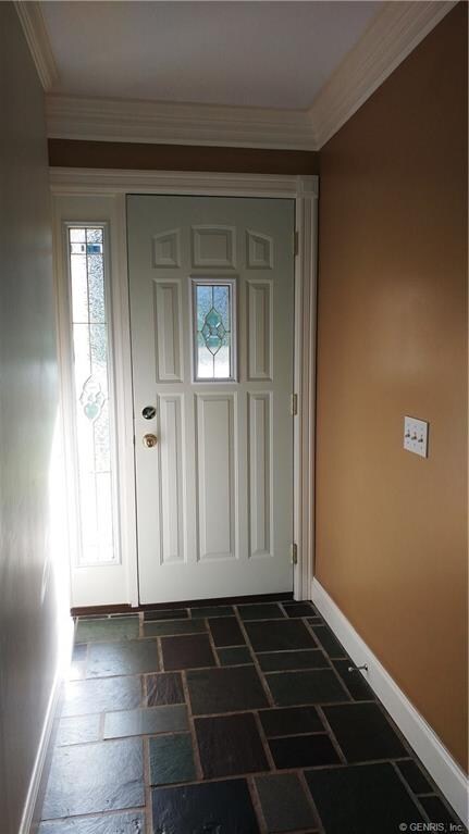 Foyer features side light, neutral wall color and slate tile flooring.
