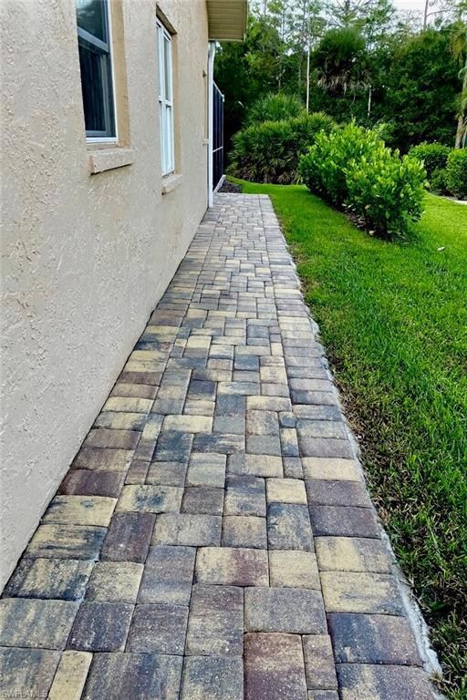 Paver walkway from front drive to rear of home.