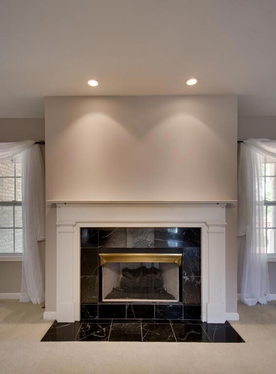 Fireplace with gas logs has a marble surround - what a great focal point for this room