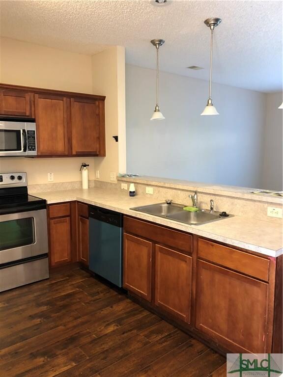 Kitchen opens to great room.  Pendulum lights over