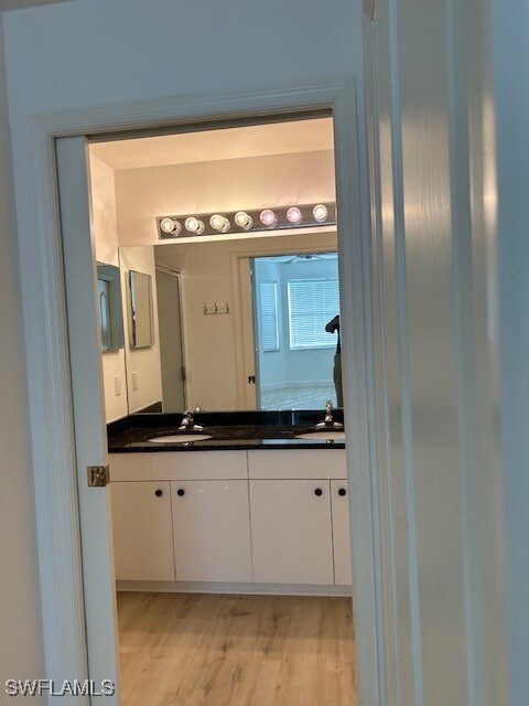 Bathroom with vanity and hardwood / wood-style flo