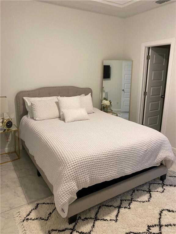 Bedroom featuring light tile floors