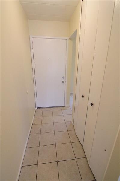 Entryway with ceramic tile.