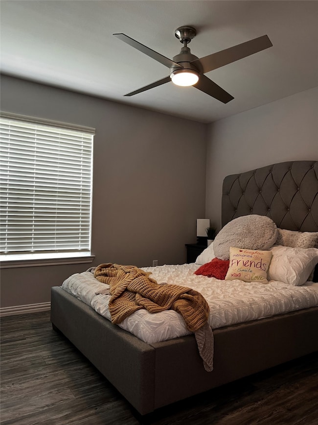 Bedroom featuring dark wood-style flooring and a ceiling fan