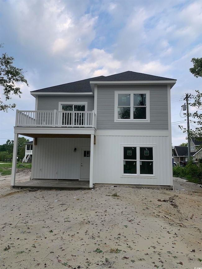 Back of property featuring a balcony