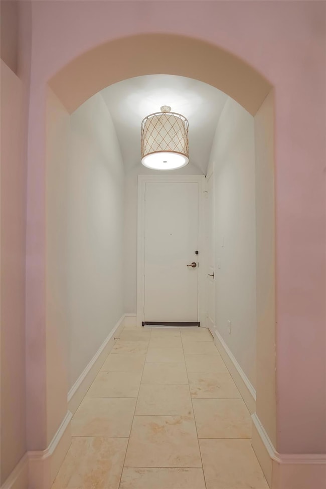 Doorway to outside with arched walkways and basebo